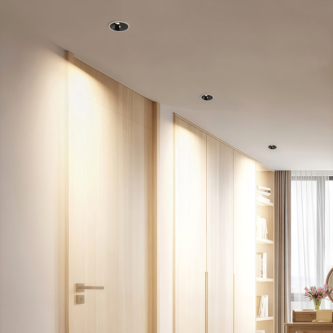 Minimalist adjustable spotlights with glass shade chandelier styling highlighting contemporary wall art in bright interior.