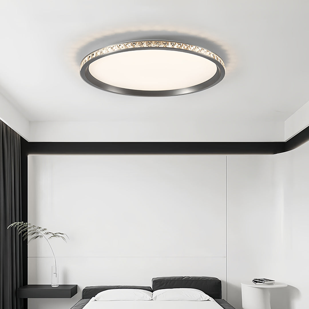 Round flush mount LED light creating ambient lighting in minimalist modern interior space