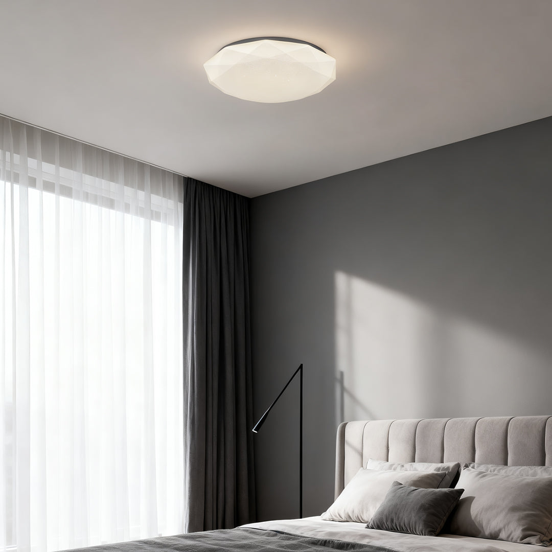 Minimalist bedroom featuring a geometric flush mount ceiling light for soft even illumination.