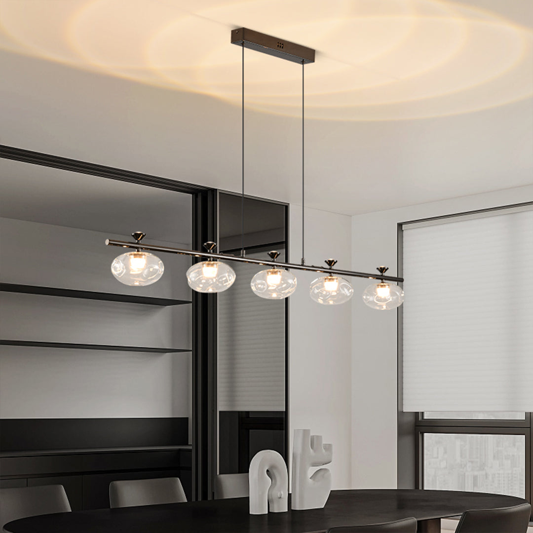 Minimalist linear glass chandelier with sleek black design in contemporary open-plan space