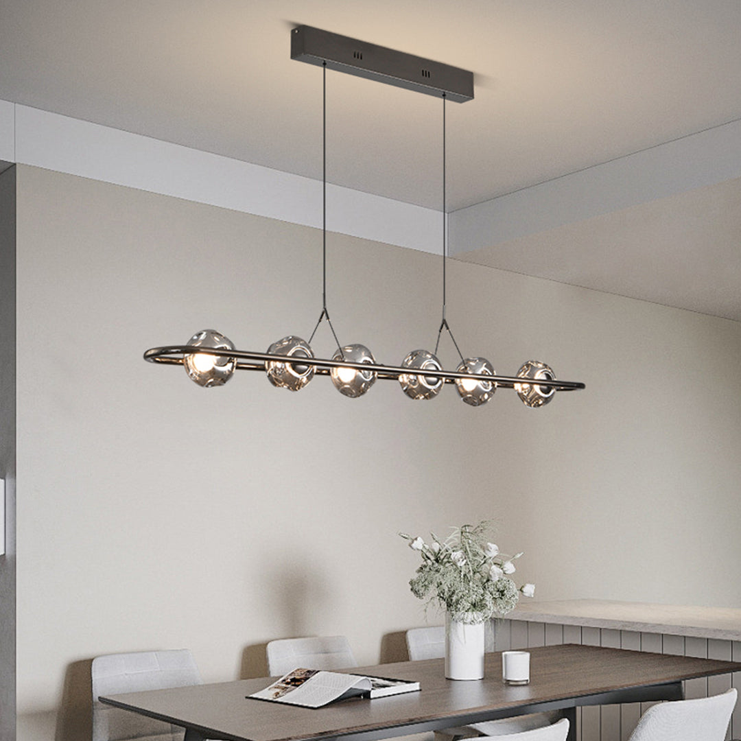 Minimalist rise and fall pendant light with sleek black design in contemporary open-plan space