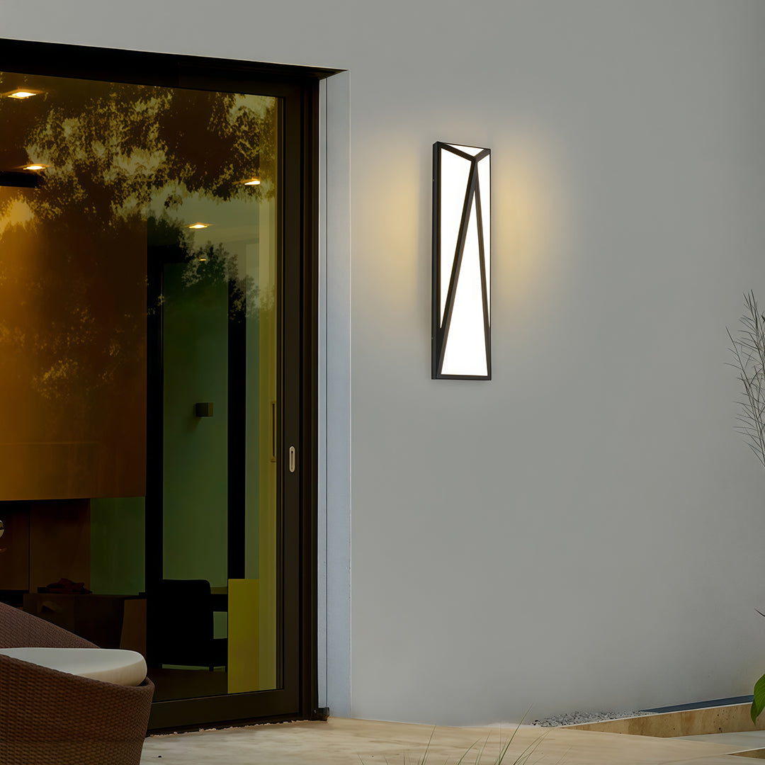 Minimalist exterior wall light black featuring glass shade chandelier design illuminating dark wood door entrance at night.