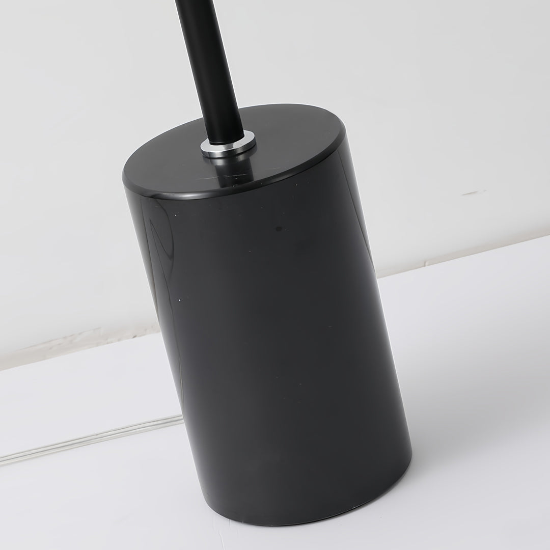 Minimalist floor lamp curved base detail showcasing sculptural design and smooth black finish craftsmanship