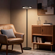 Minimalist floor light placed beside modern armchair in living room.