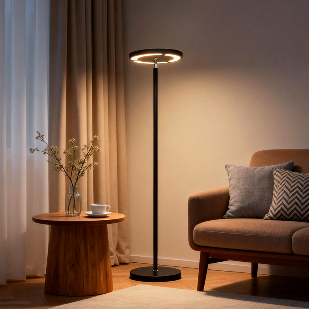 Minimalist floor light illuminating cozy reading corner at night.