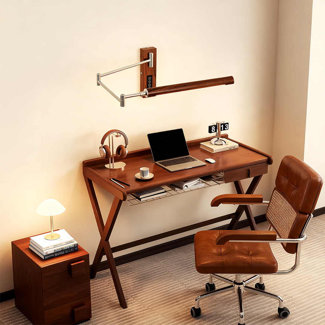 Minimalist folding swing wall light providing focused illumination over a home office workspace.