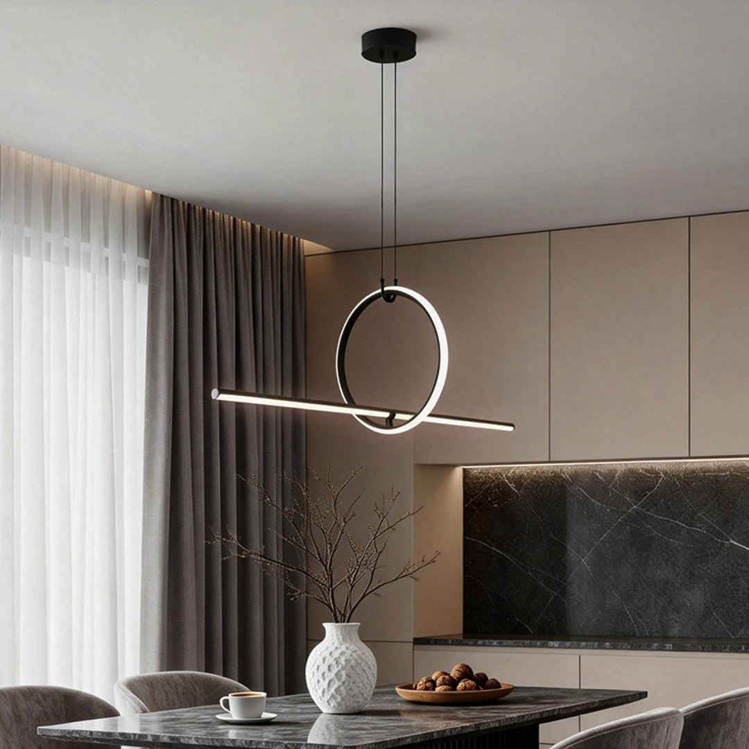 Minimalist geometric pendant light fixture with a circular ring, providing ambient light in a chic kitchen.