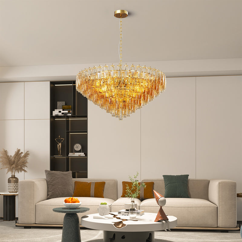 Gold glass pendant chandelier as the centerpiece in a minimalist dining room setup.