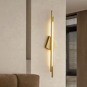 Minimalist gold metal floor lamp with a diamond-shaped shade in a contemporary space