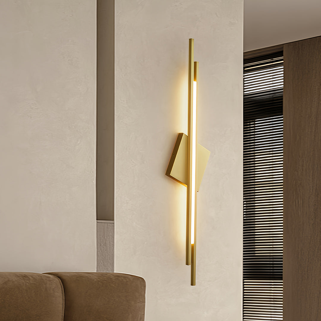 Minimalist gold metal floor lamp with a diamond-shaped shade in a contemporary space
