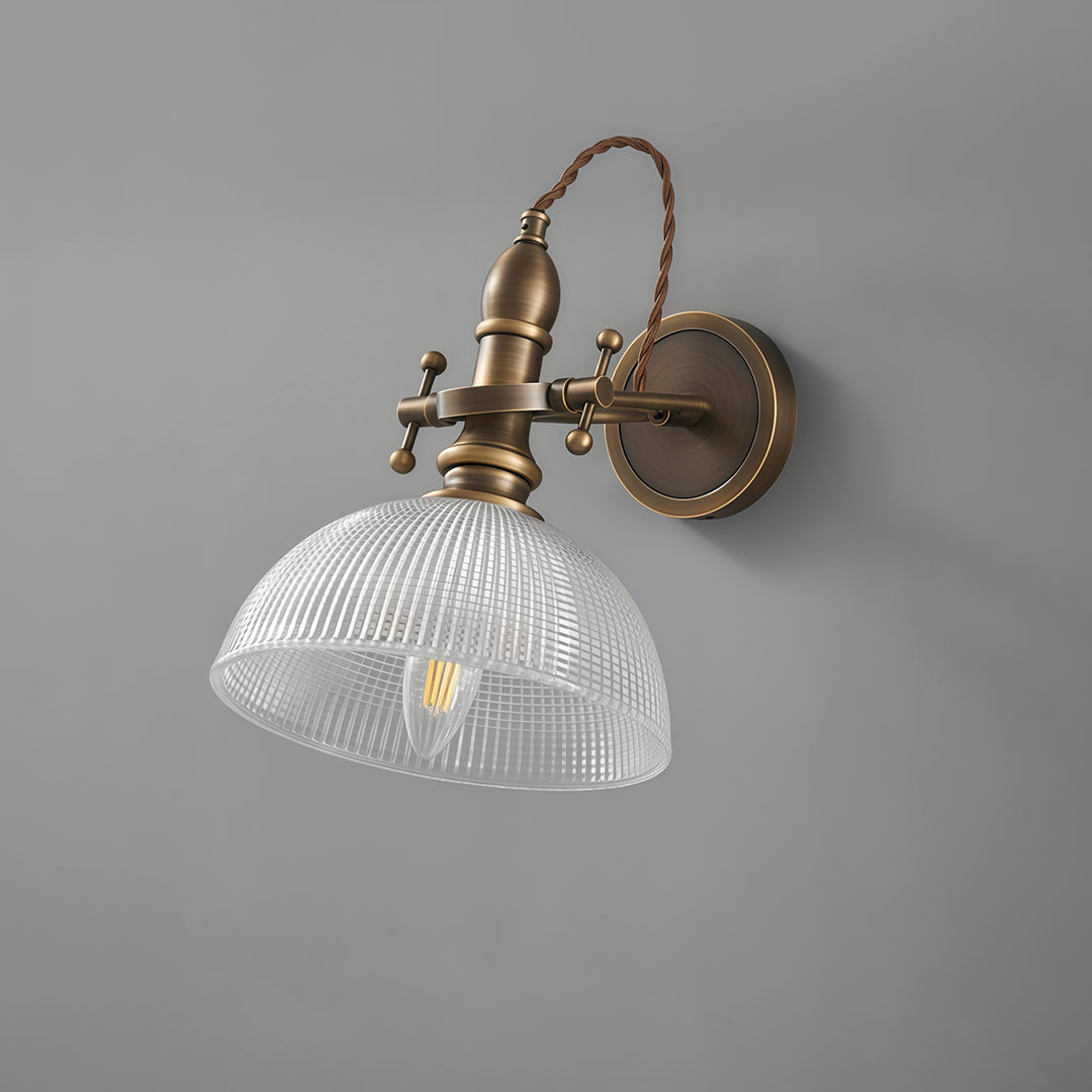 Minimalist indoor wall mount lights featuring glass shade chandelier design with textured prismatic dome on gray wall.