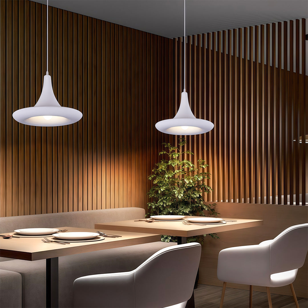 Minimalist Japanese pendant light fixtures featuring glass shade chandelier styling in white cone illuminating modern dining area.