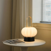 Minimalist lantern table lamp on side table creating gentle illumination in contemporary space