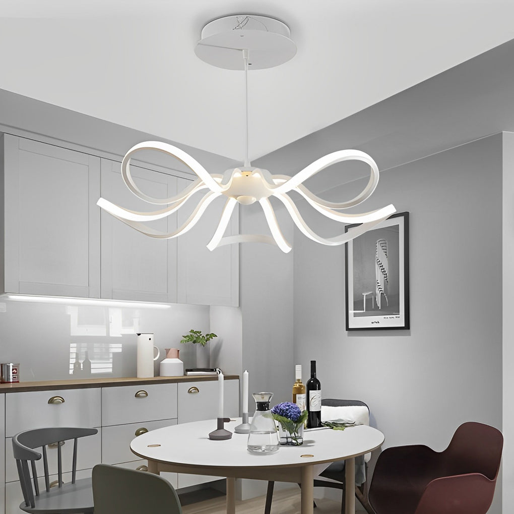 Minimalist LED ribbon chandelier illuminating a round dining table in a contemporary kitchen setting.