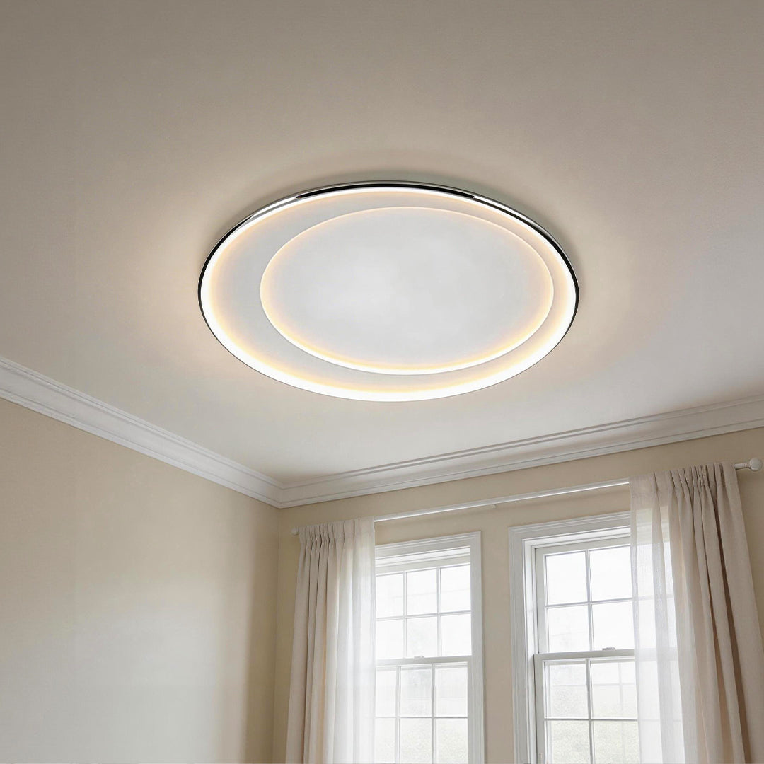Minimalist led round flush mount light with a sleek double illuminated halo on a white ceiling.