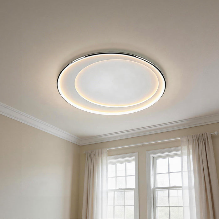 Minimalist led round flush mount light with a sleek double illuminated halo on a white ceiling.