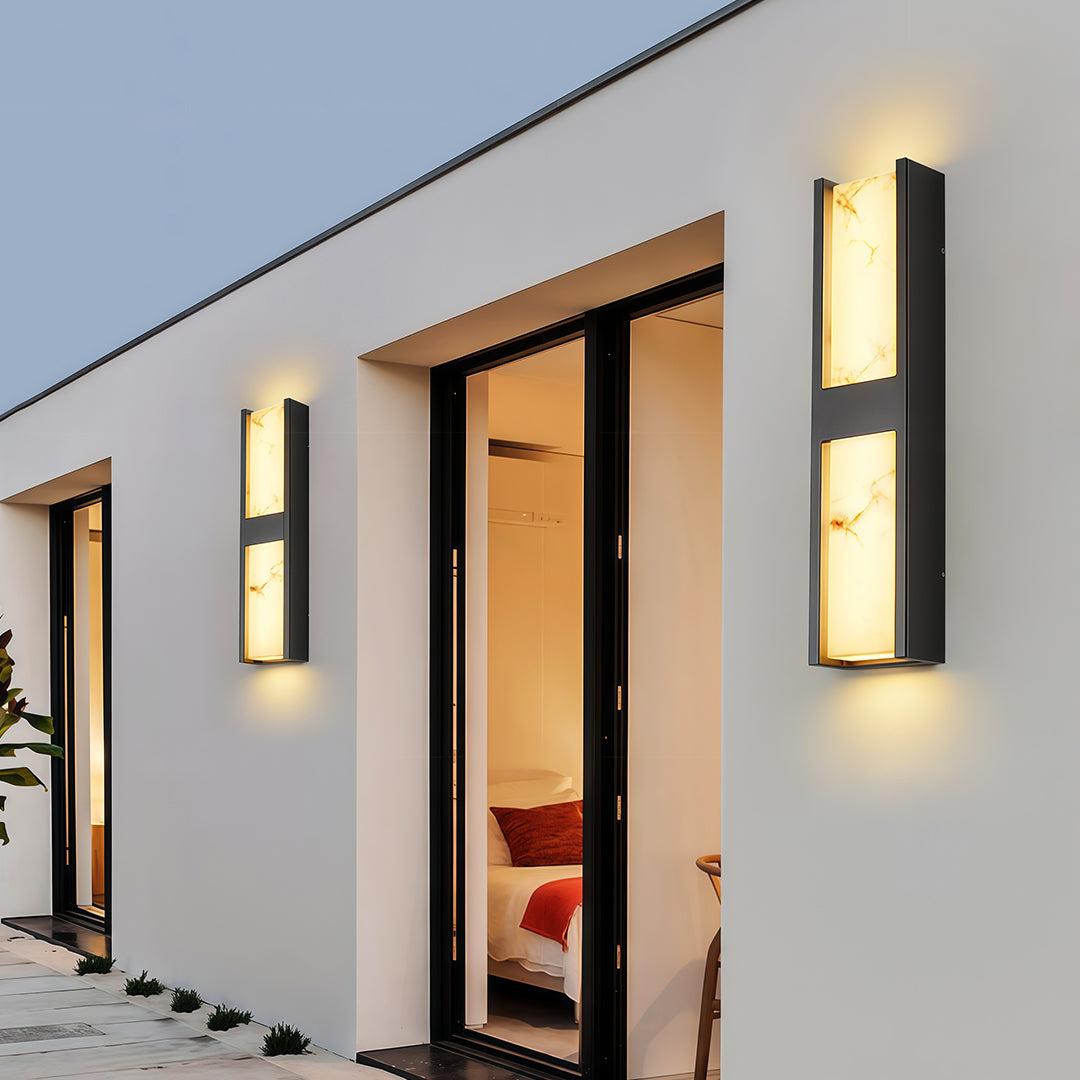 Minimalist LED wall sconce light fixtures featuring glass shade chandelier design creating dramatic uplighting and downlighting effect.