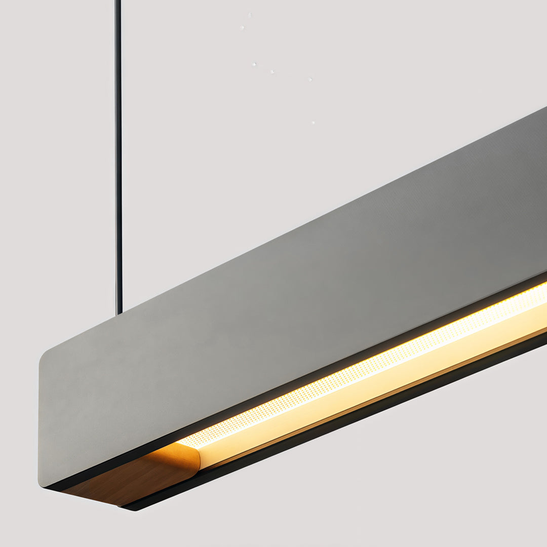 Minimalist linear pendant light fixtures featuring slim rectangular housing and warm illumination.