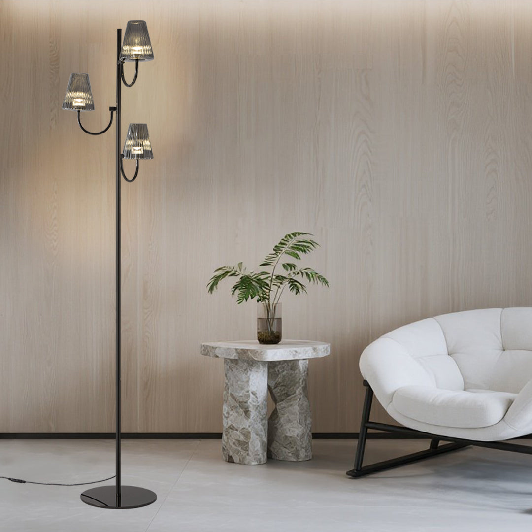 Minimalist living room featuring sculptural floor lamp with multiple glass shades and clean aesthetic