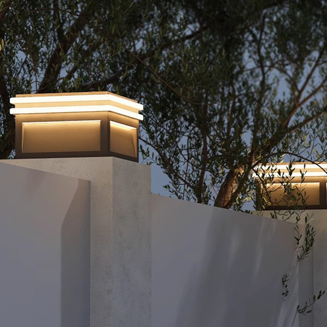 Minimalist metal pillar lights with clean lines and integrated lighting elements for contemporary outdoor architecture