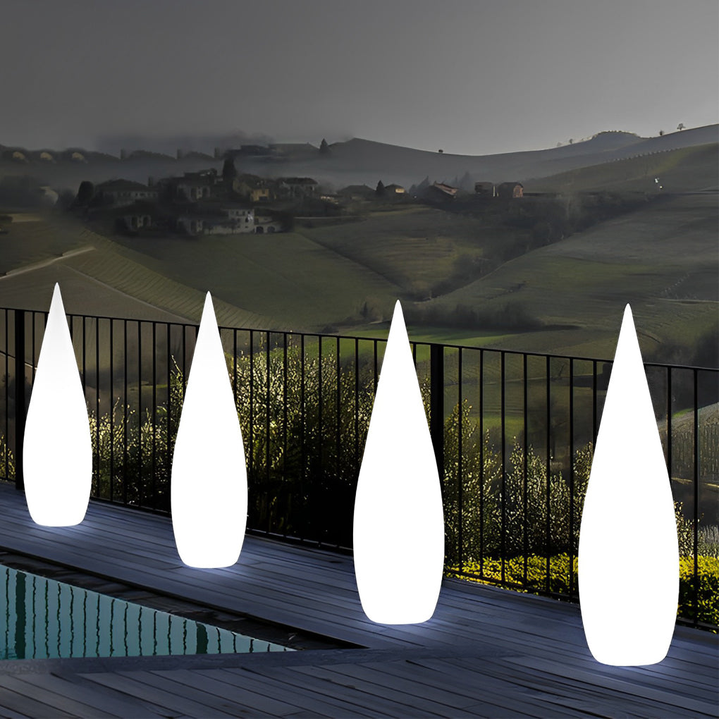 Minimalist modern teardrop outdoor light creating ambient poolside illumination at night.