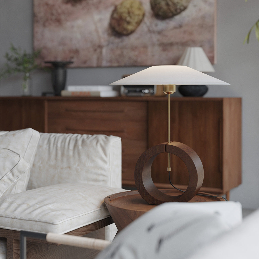 Minimalist natural wood table lamp glowing softly in dark background.