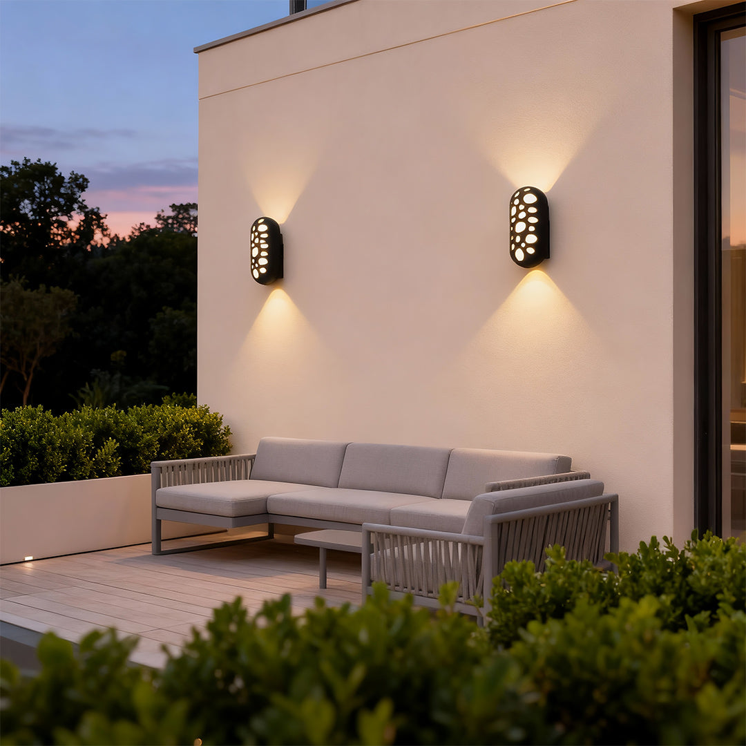 Minimalist outdoor up down wall lights with glass shade chandelier design providing soft uplighting and downlighting on outdoor terrace.