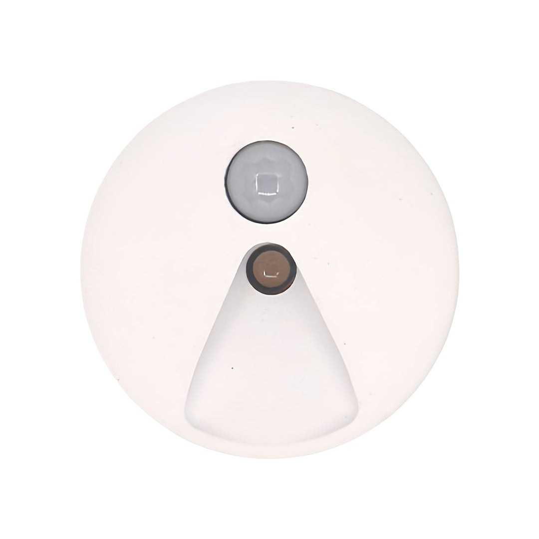 Minimalist round interior stair step lights with a white trim, featuring a downward hexagonal light aperture and integrated motion sensor for smart, safe illumination.