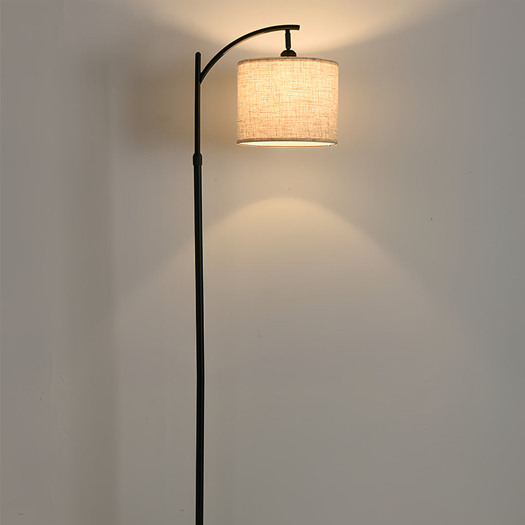 Minimalist living space with small black pendant light creating soft lighting through natural fabric shade
