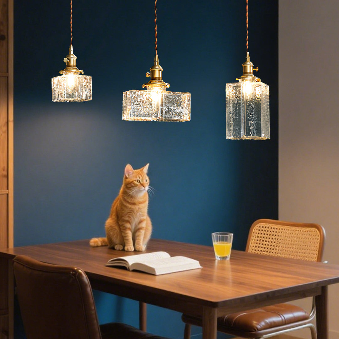 Minimalist square glass pendant light with smooth clear glass and brass hardware for clean modern design