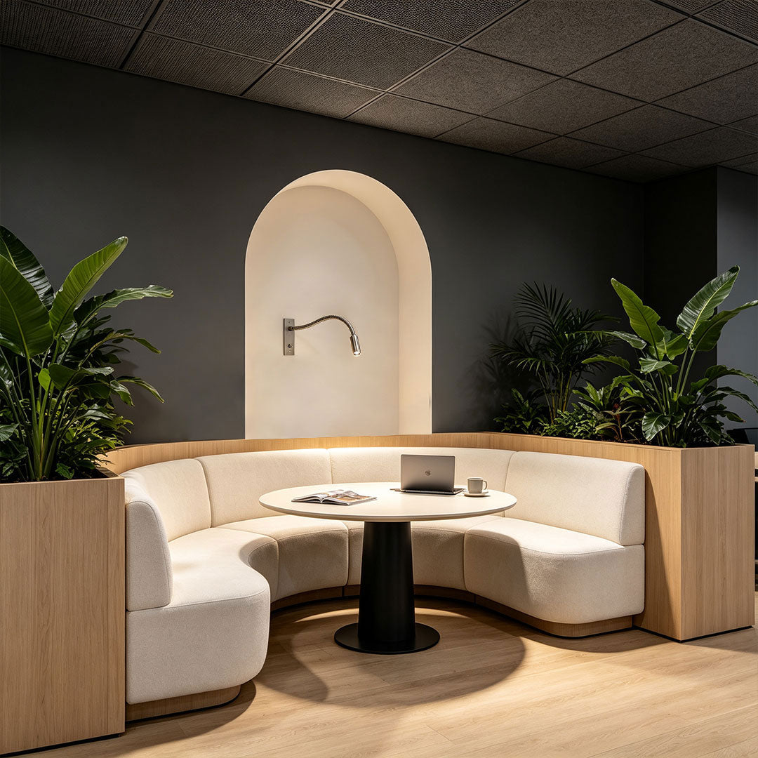 Minimalist swing arm wall mount light featured in a modern lounge seating area.