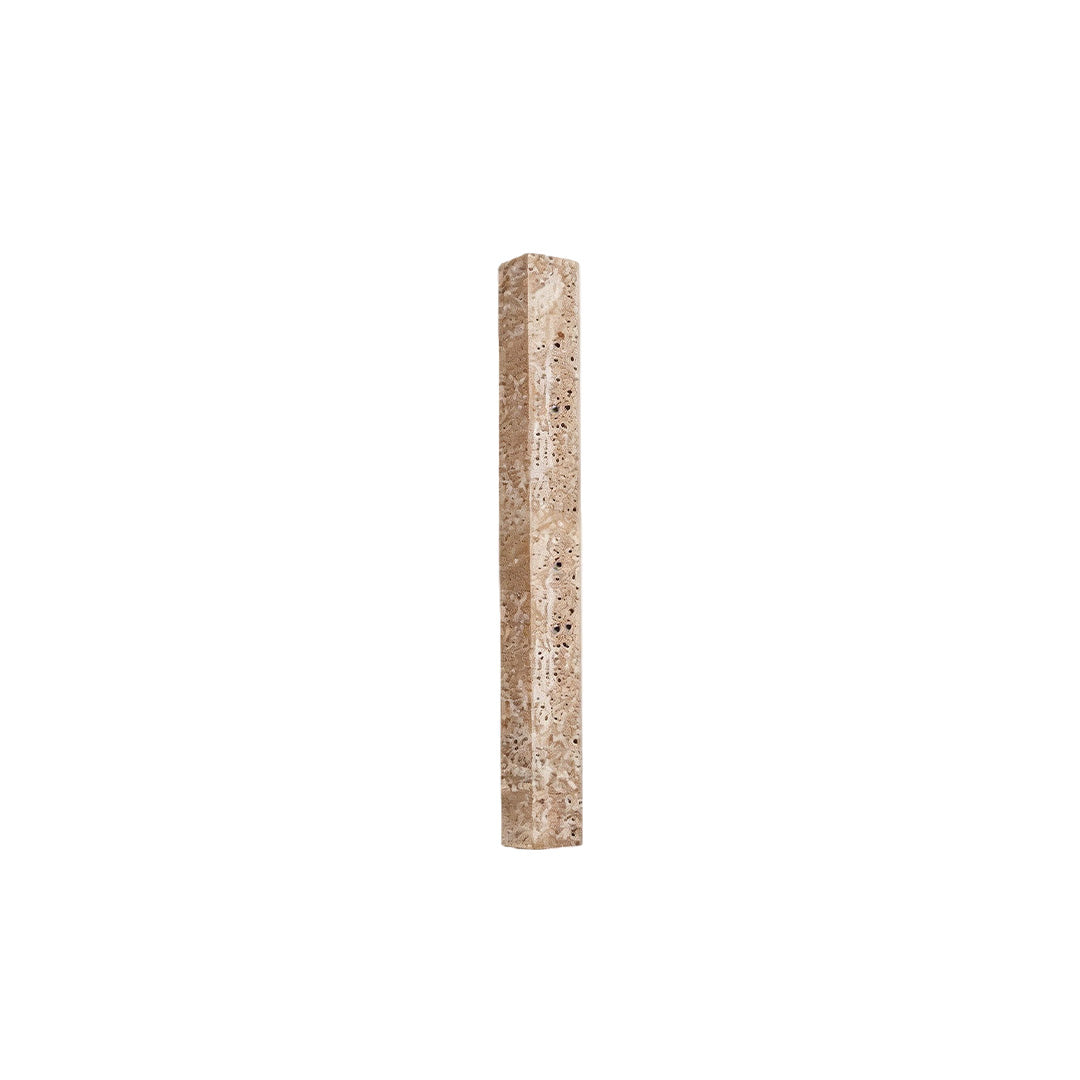 Minimalist up down lighting wall sconce with a narrow textured stone bar on white background.