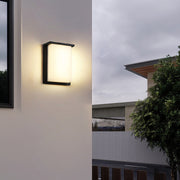 Minimalist wall light mounted in contemporary hallway with clean white wall finish