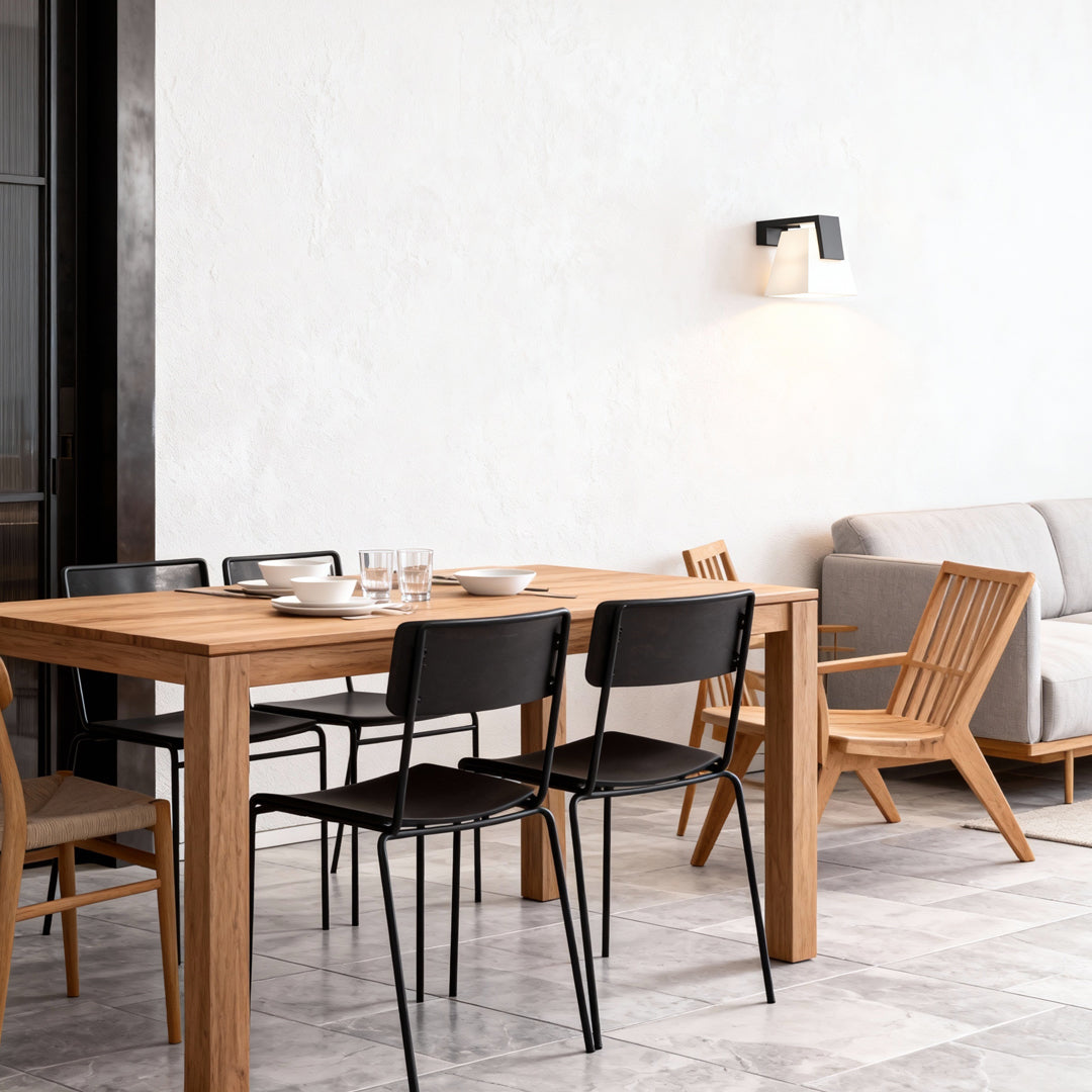 Minimalist wall mounted outdoor lights installed above an outdoor dining area with soft ambient lighting.