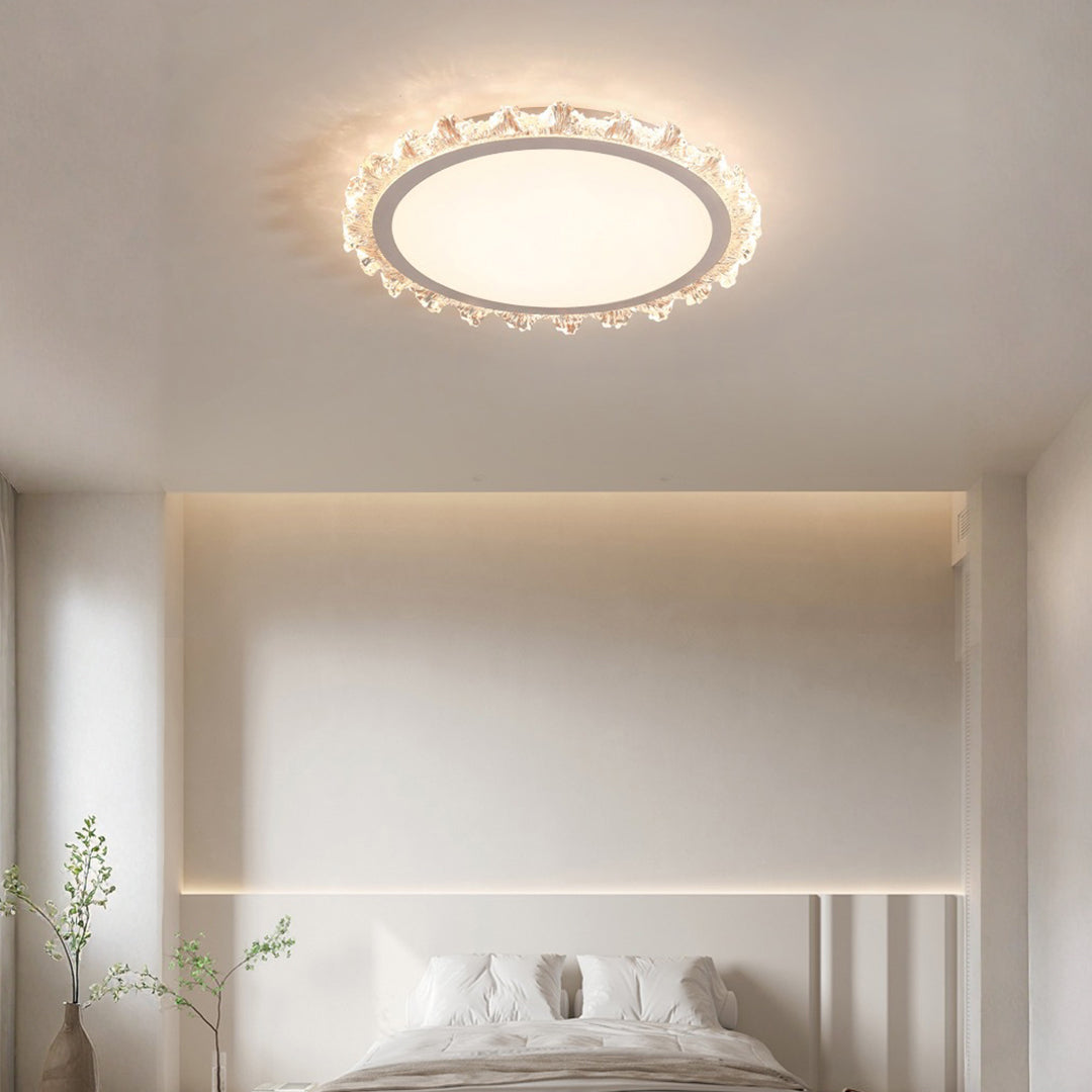 Elegant white round led ceiling light adding a soft glow to a minimalist white bedroom setting.