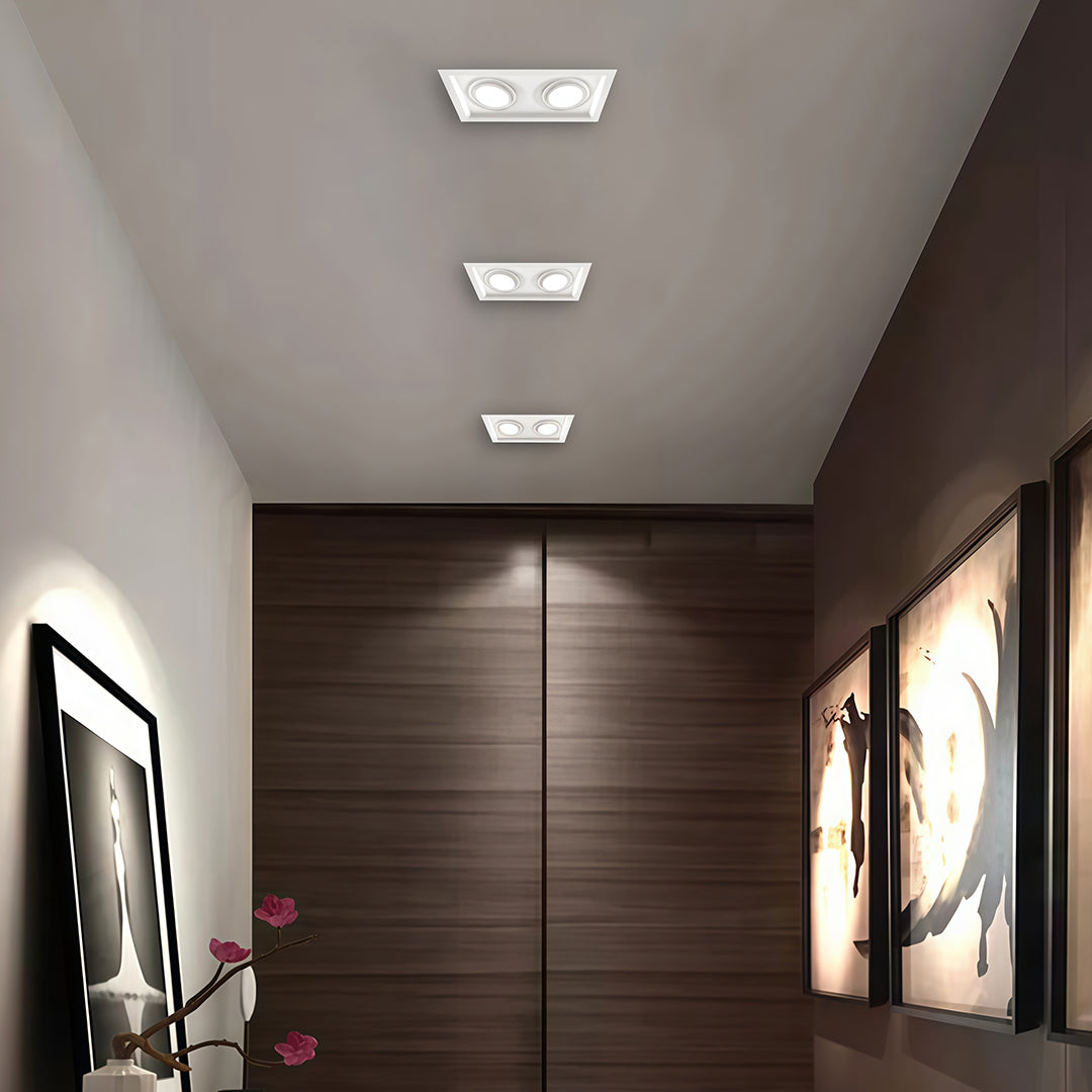 Minimalist white LED indoor spotlight with glass shade chandelier aesthetic illuminating sleek kitchen and dining area.
