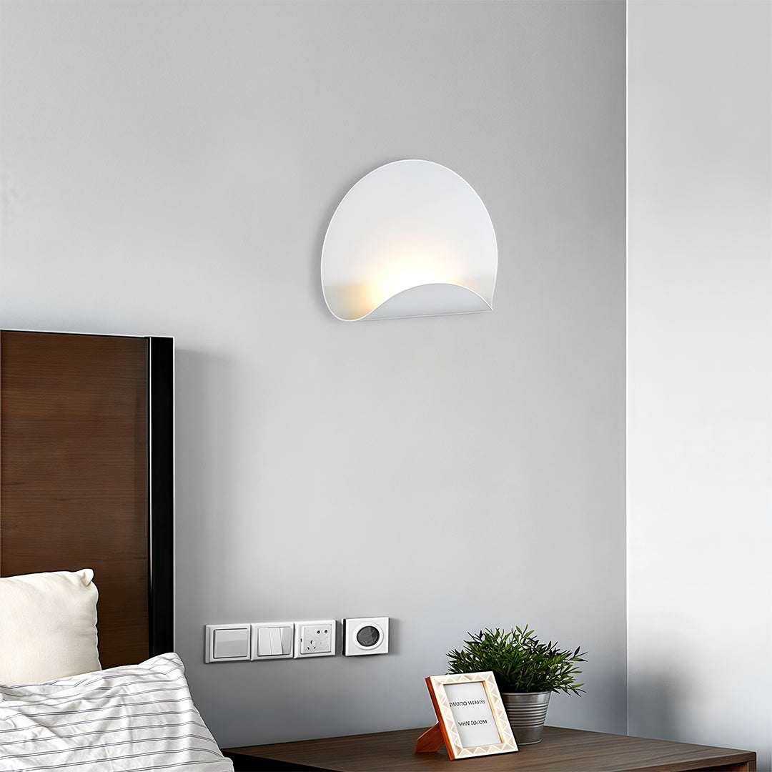 Minimalist white wall lights fixture with a smooth matte finish, used as accent lighting in a clean, modern interior space.
