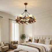 Modern antler chandelier installed in a cozy bedroom with rustic luxury interior styling.