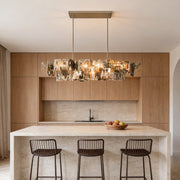 Modern art deco chandelier with a unique geometric design, illuminating a stylish kitchen island.