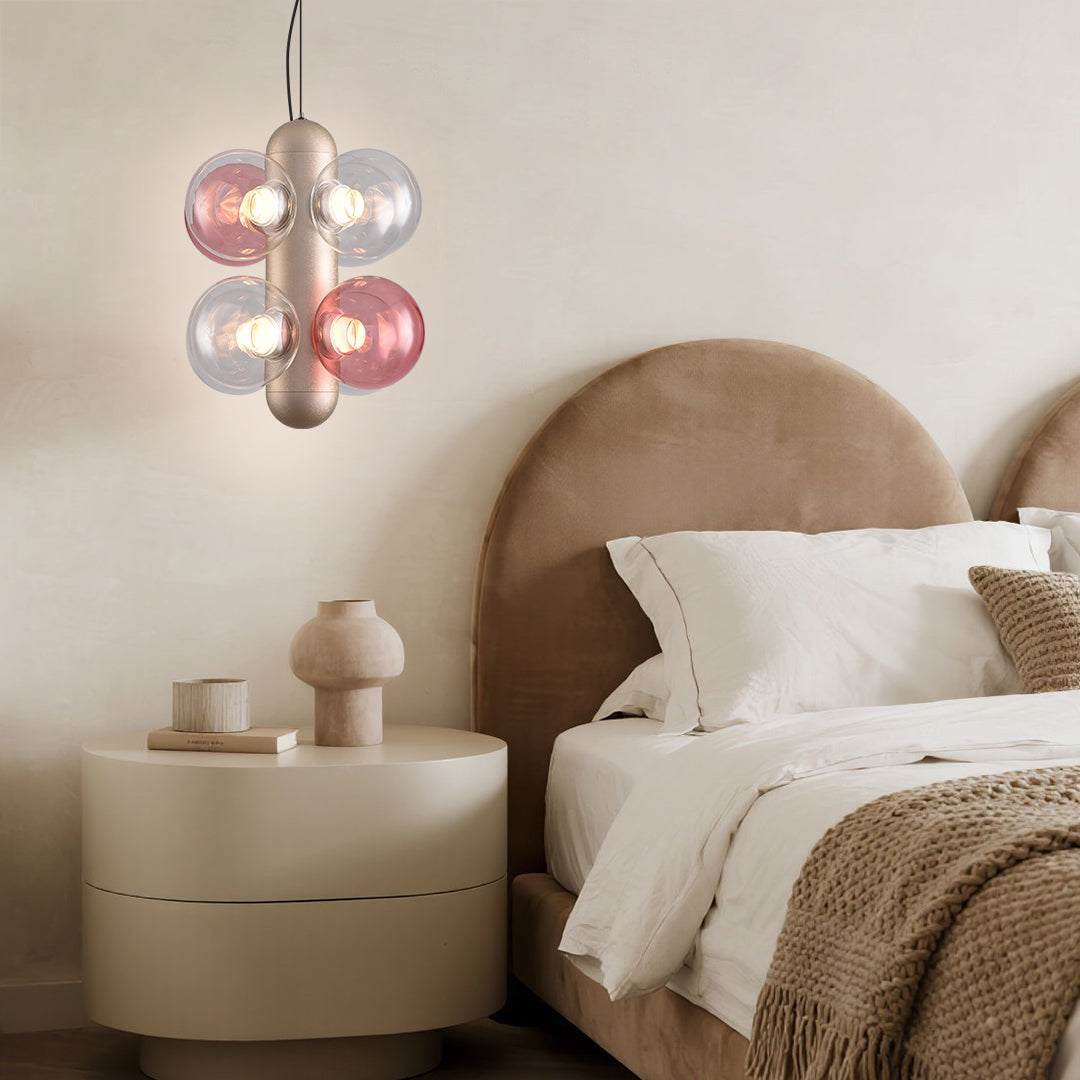 Modern bar interior featuring multiple bubble chandeliers with pink and clear glass elements