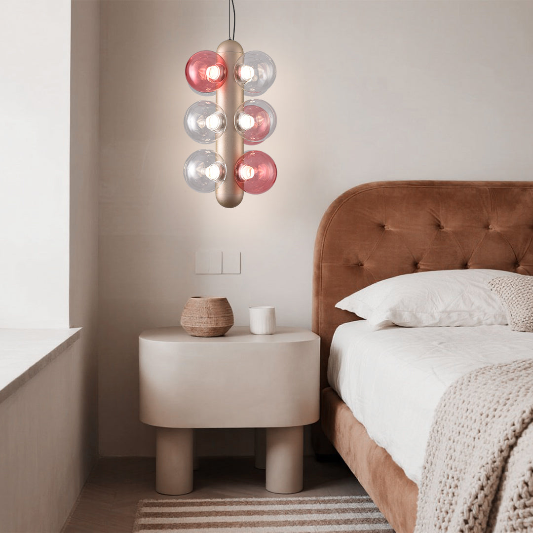 Modern bar interior featuring multiple bubble chandeliers with pink and clear glass elements