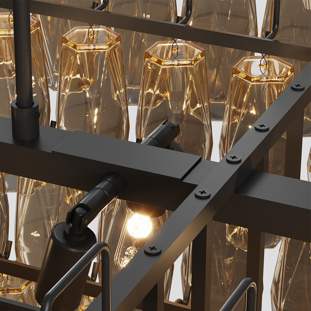 Detailed look at the lighting base of a modern gold glass pendant chandelier with warm glow.
