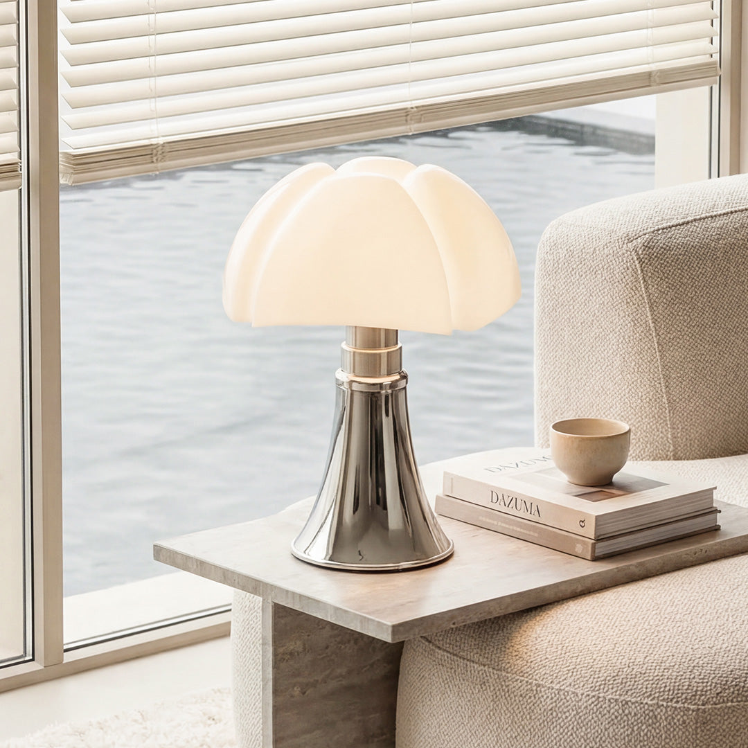 Modern bauhaus table lamp with white scalloped mushroom shade and chrome base on stone tables.
