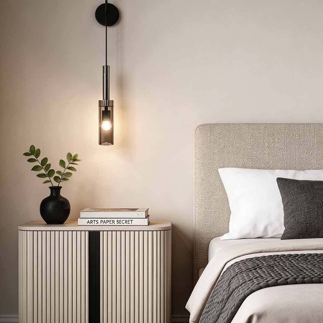 Sleek bedside hanging wall lamp illuminating a modern bedroom with a textured nightstand.
