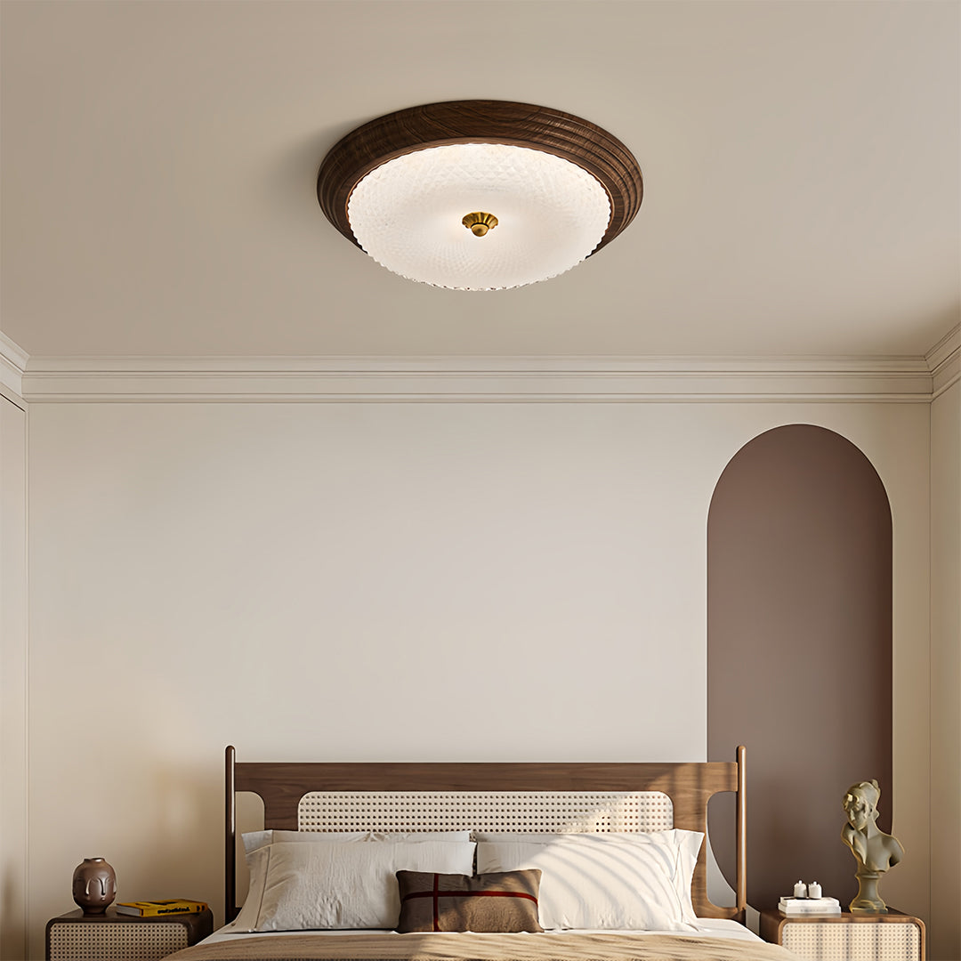 Modern bedroom with vintage art deco flush mount ceiling light, elegant lighting above a bed