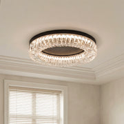 Modern black ceiling flush mount light with a thick ring of textured clear crystal prisms.