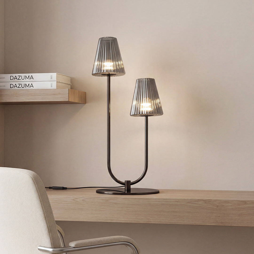 Modern black elegant table lamps with two ribbed glass shades on a minimalist wooden work desk.