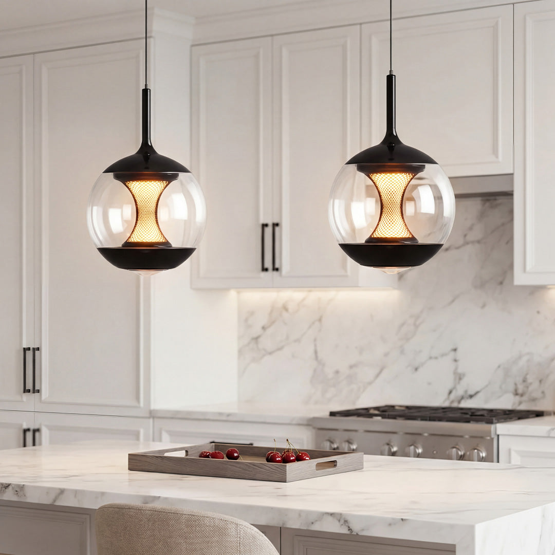 Modern orb pendant light with black metal trim and a honeycomb mesh core in a white kitchen.