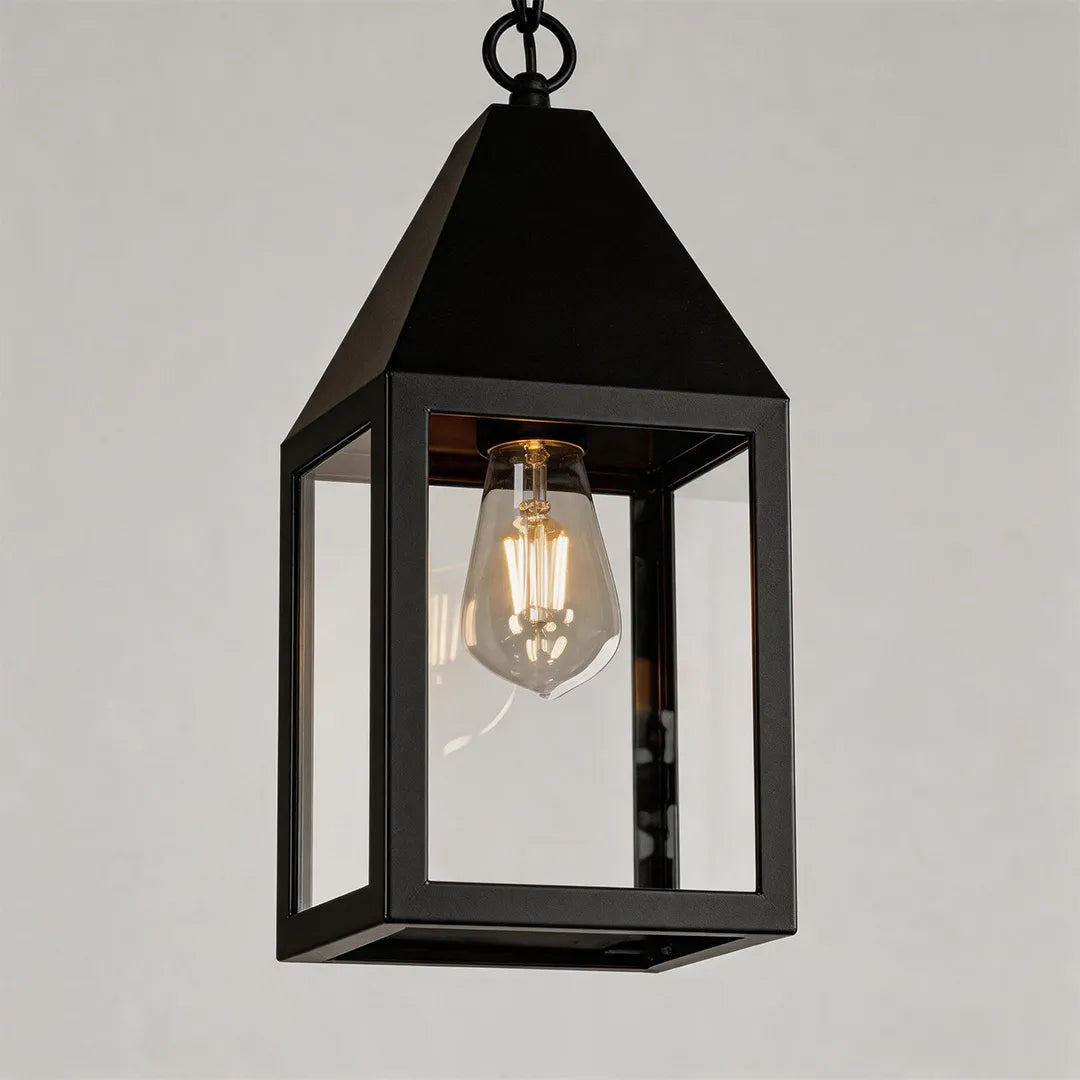 Modern black outdoor pendant light product image featuring a rectangular lantern frame with clear glass panels and exposed bulb.