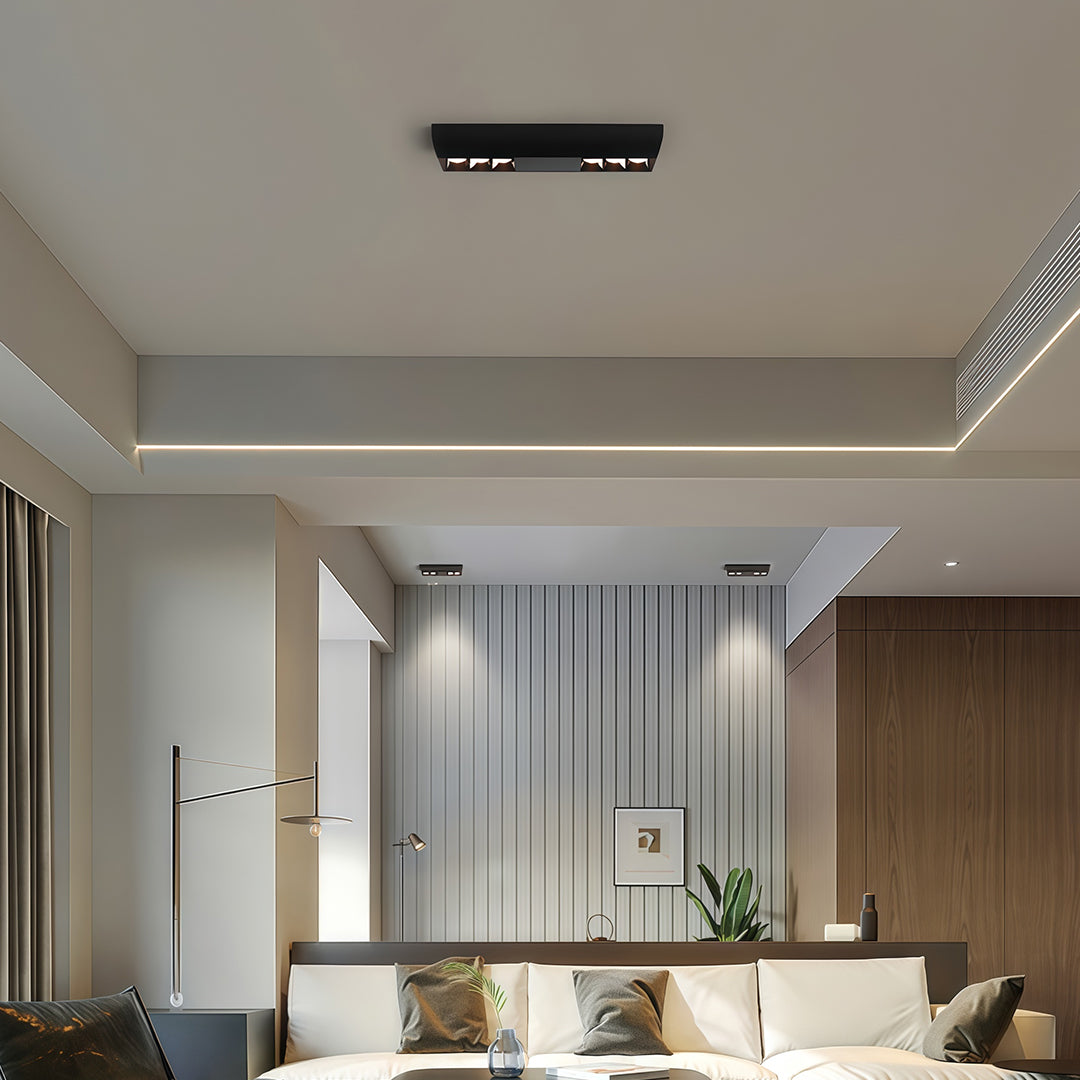 Modern ceiling design featuring a black square downlights bar complementing the ambient cove lighting.